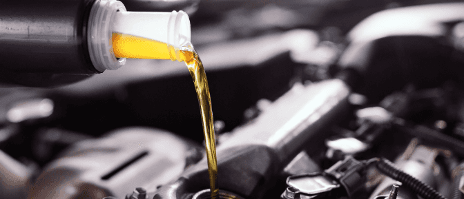 -up of fresh motor oil being poured into an engine during a vehicle service.-up of fresh motor oil being poured into an engine during a vehicle service.
