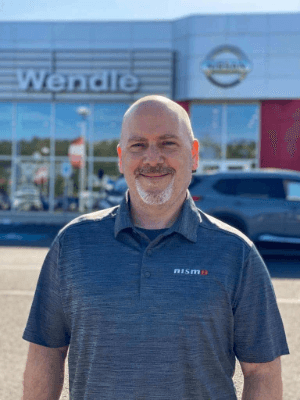 Man standing in front of Wendle Nissan dealership