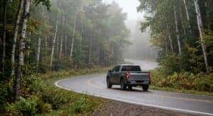 Chevrolet pickup truck driving through northern Wisconsin forest highway connecting Antigo and Merrill for brake service visit