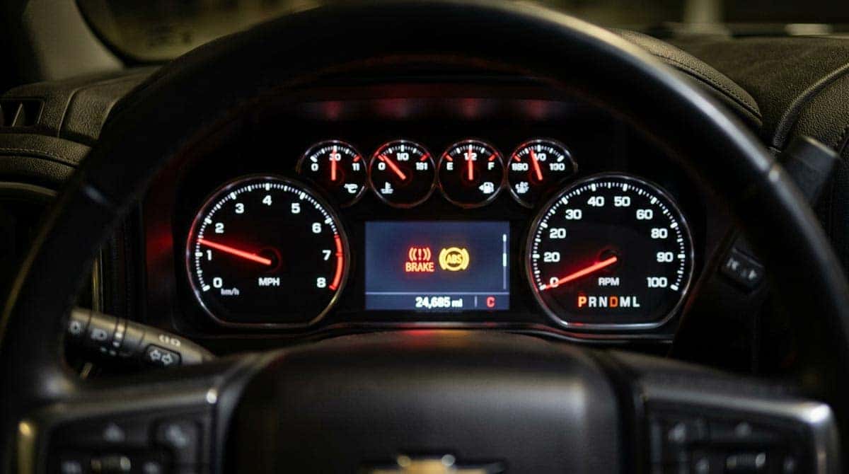 Brake warning light and ABS light illuminated on Chevrolet Silverado instrument cluster indicating brake service needed