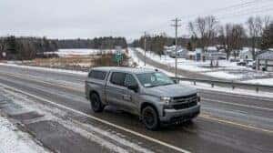 Chevrolet pickup truck driving south on a northern Wisconsin highway from Tomahawk toward Merrill for oil change service