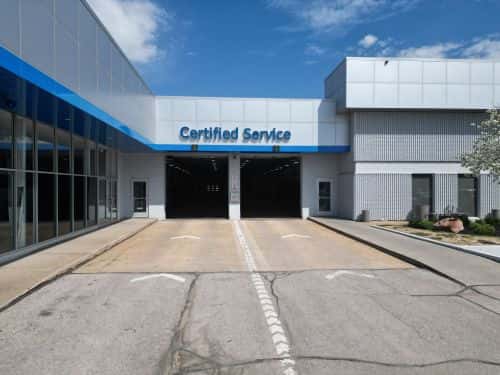 Certified Service entrance at Woodhouse Chevrolet Omaha under a blue sky.